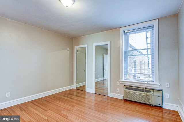 unfurnished bedroom with light wood-type flooring