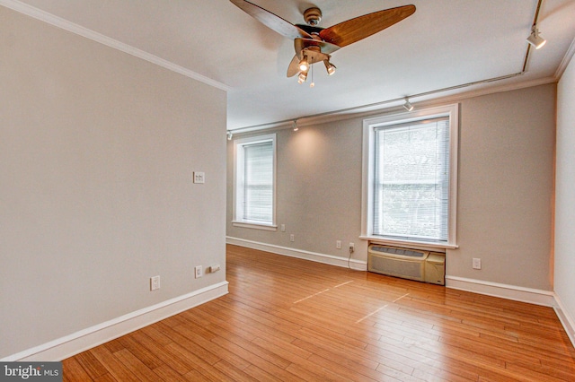 spare room featuring a wall mounted air conditioner, light hardwood / wood-style flooring, rail lighting, and ceiling fan