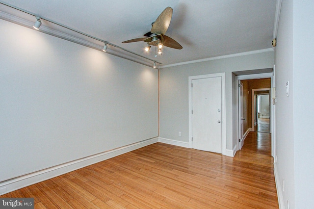 unfurnished room featuring light hardwood / wood-style flooring, rail lighting, ceiling fan, and ornamental molding