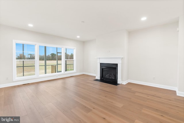 unfurnished living room featuring light hardwood / wood-style floors