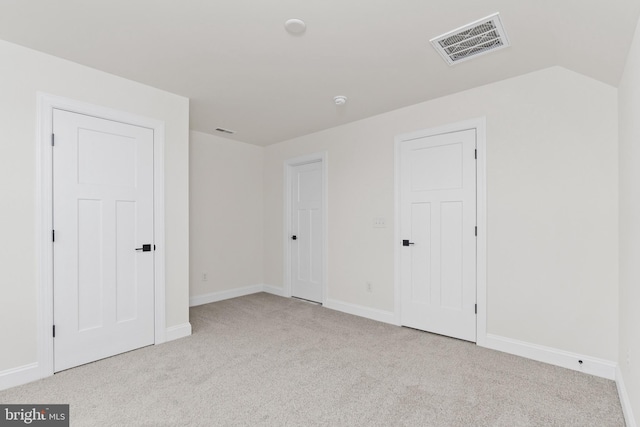 unfurnished bedroom with light colored carpet