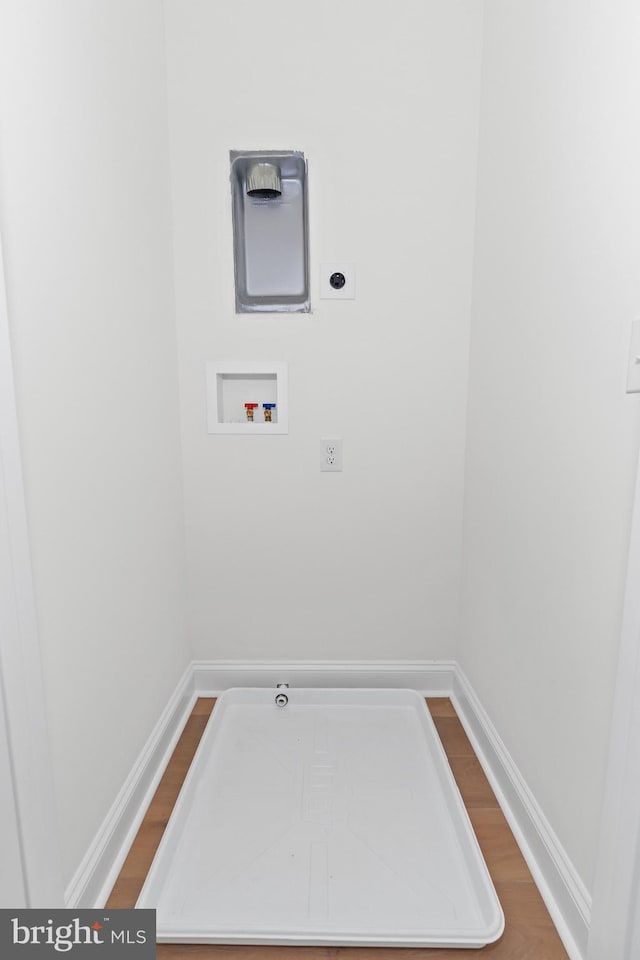 washroom with hardwood / wood-style floors, electric dryer hookup, and washer hookup