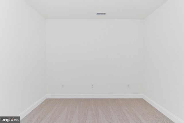 unfurnished room with light carpet