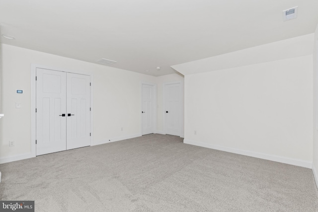 unfurnished room with light colored carpet