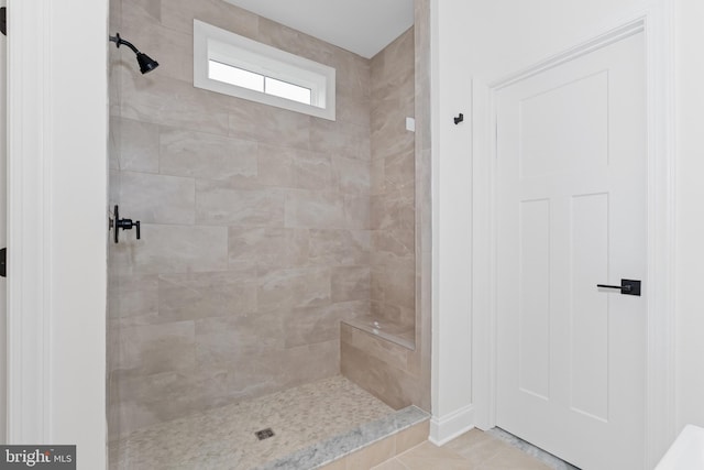 bathroom featuring tile patterned floors and tiled shower