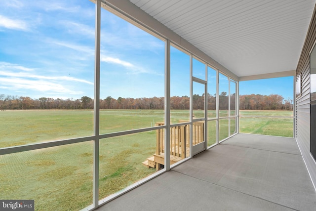 unfurnished sunroom with a rural view