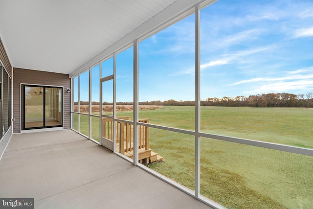 unfurnished sunroom with a rural view