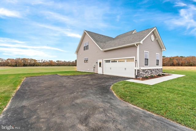 view of home's exterior with a garage and a lawn