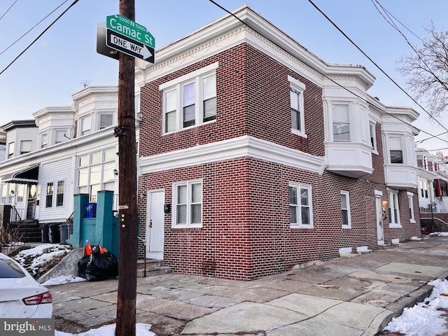 view of side of property with brick siding