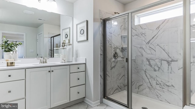 bathroom with a shower with shower door, vanity, tile patterned flooring, and plenty of natural light