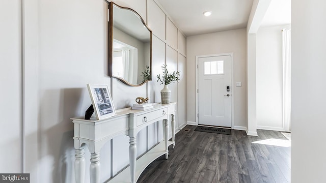 entryway with dark hardwood / wood-style flooring