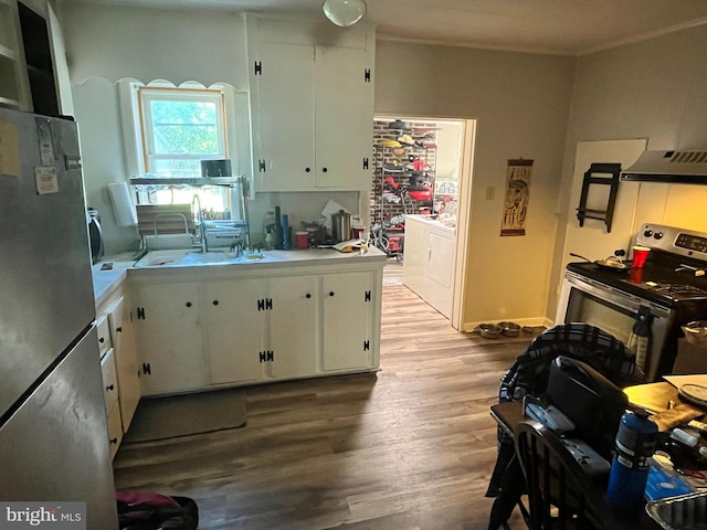 kitchen featuring white cabinetry, stainless steel appliances, washer / clothes dryer, and sink