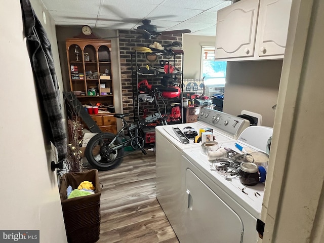 washroom featuring cabinets, independent washer and dryer, and light wood-type flooring