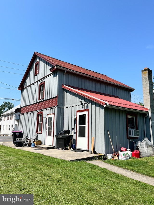 back of property with cooling unit, a yard, and a patio