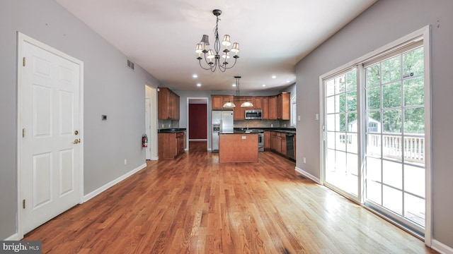 kitchen featuring a center island, decorative light fixtures, light hardwood / wood-style flooring, and stainless steel appliances