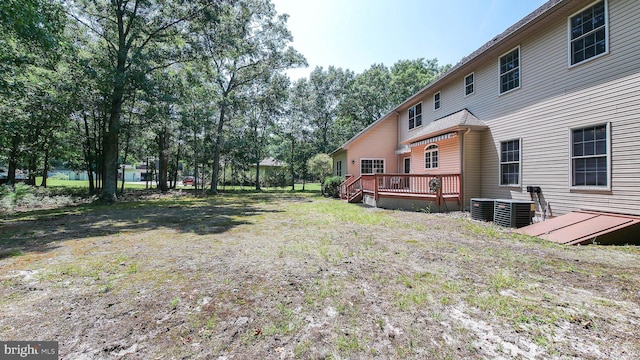 view of yard featuring a deck and central AC