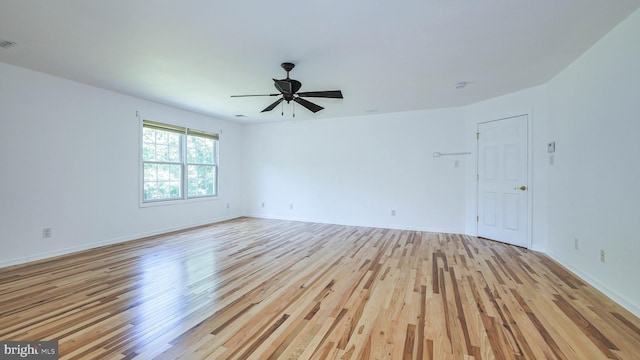 unfurnished room with light wood-type flooring and ceiling fan