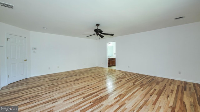 empty room featuring ceiling fan and light hardwood / wood-style flooring