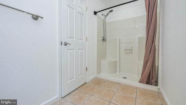 bathroom featuring tile patterned floors and a shower with shower curtain