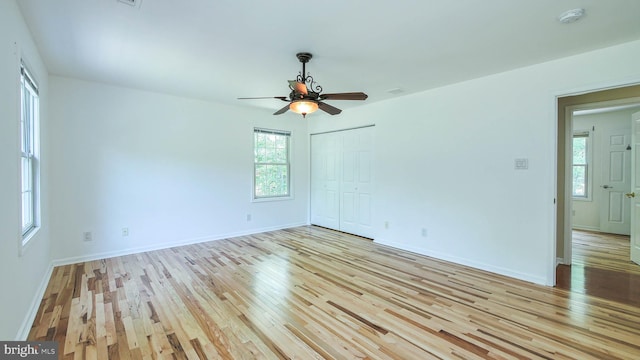 empty room featuring light wood-type flooring and ceiling fan