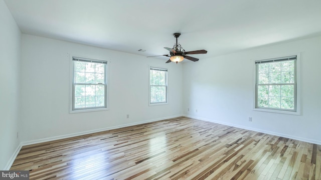 spare room with light hardwood / wood-style flooring and ceiling fan