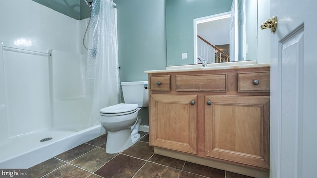 bathroom featuring curtained shower, vanity, tile patterned flooring, and toilet