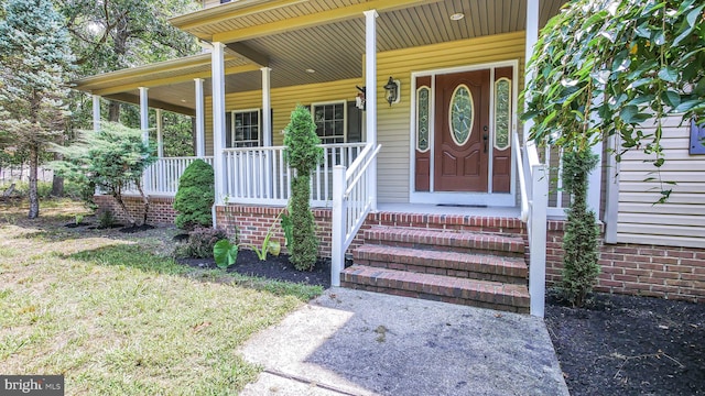 view of exterior entry with covered porch