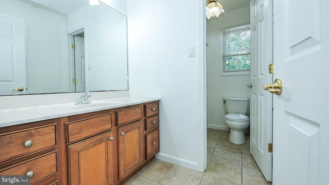 bathroom featuring tile patterned floors, toilet, and vanity