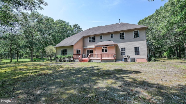 back of property featuring a yard and a wooden deck