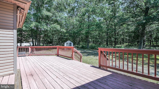 wooden deck with a storage shed