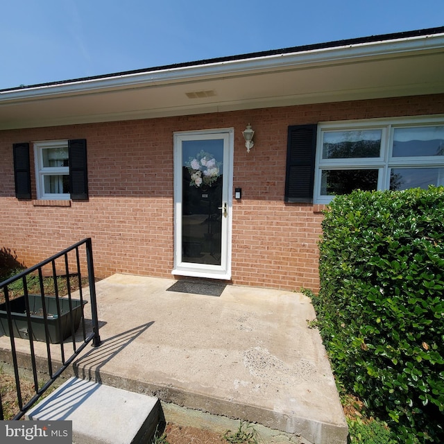 property entrance featuring a patio area