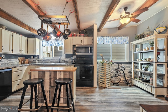 kitchen with beam ceiling, wood-type flooring, and decorative backsplash