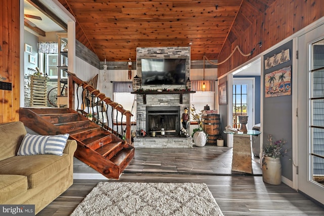 living room with a fireplace, wood-type flooring, vaulted ceiling, and wood ceiling