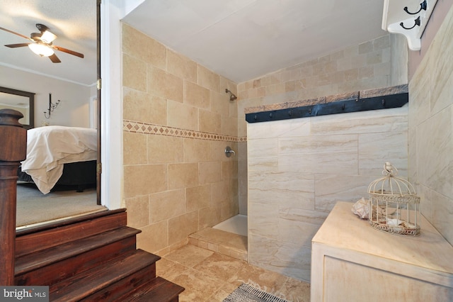 bathroom with a tile shower, tile walls, ceiling fan, and tile patterned floors