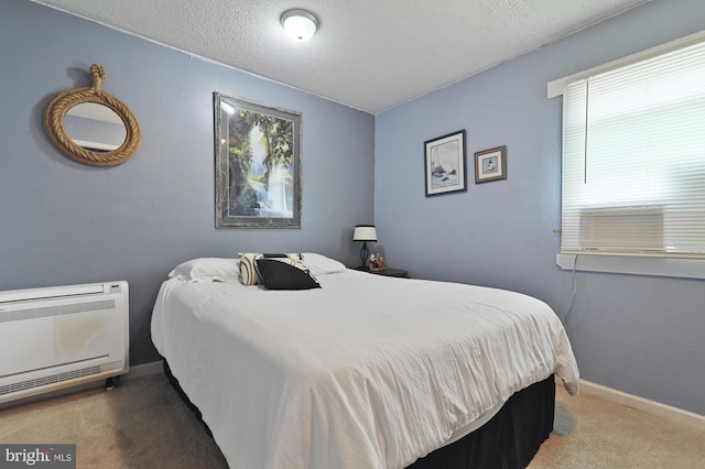 bedroom featuring cooling unit, carpet floors, and a textured ceiling