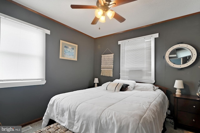 carpeted bedroom featuring crown molding, multiple windows, and ceiling fan