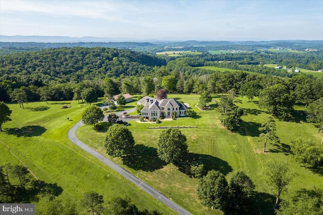 birds eye view of property featuring a view of trees