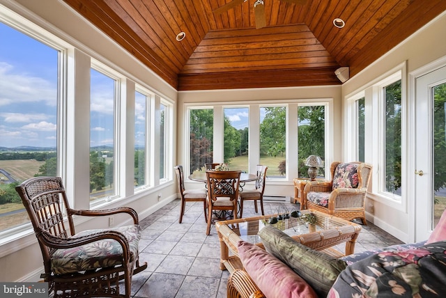 sunroom with wooden ceiling, a baseboard heating unit, and vaulted ceiling