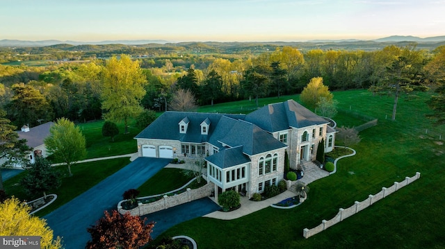 birds eye view of property with a forest view and a mountain view