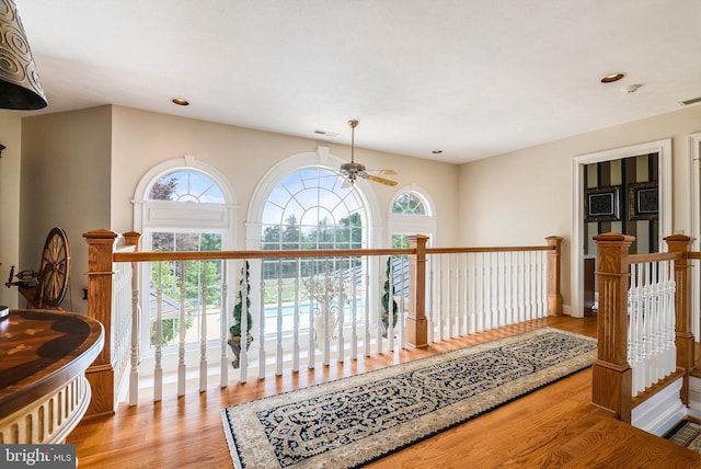 corridor featuring recessed lighting, visible vents, an upstairs landing, and wood finished floors