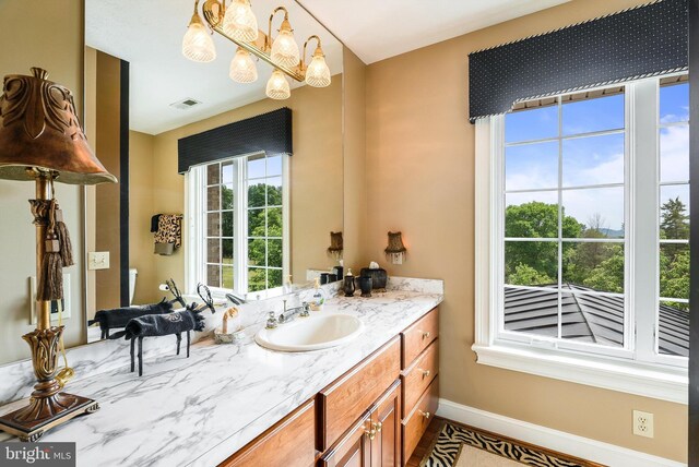 bathroom with vanity and a notable chandelier