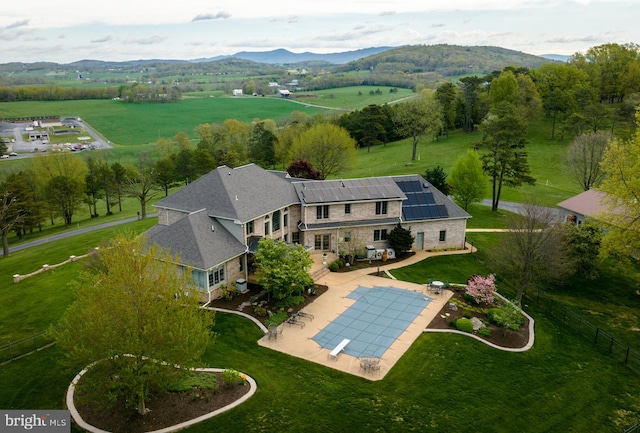 birds eye view of property with a mountain view and a rural view