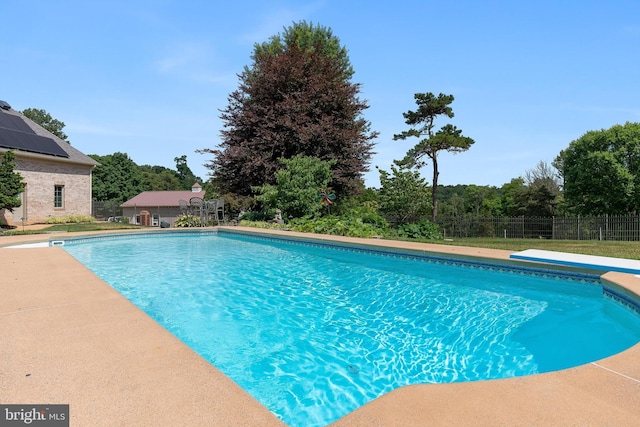 view of swimming pool featuring a fenced in pool and fence