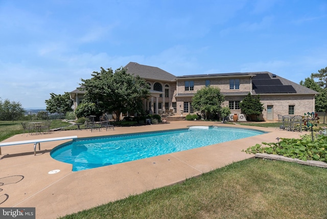 outdoor pool with a patio area