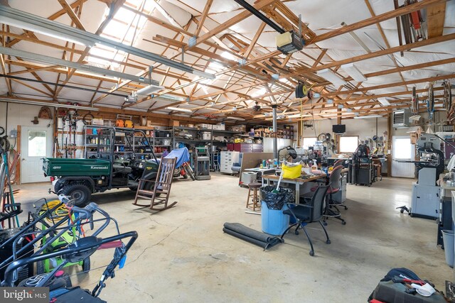 garage featuring a garage door opener and a workshop area