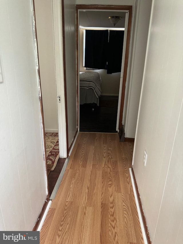 hallway with light hardwood / wood-style flooring