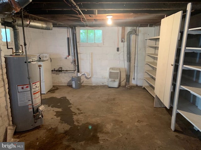 basement with gas water heater and washer / dryer