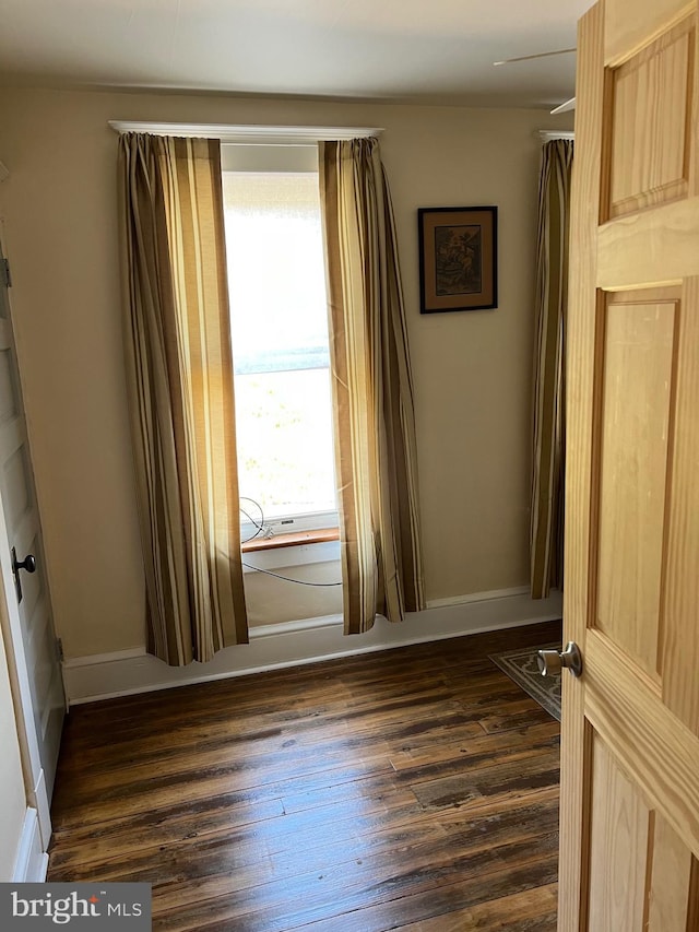 empty room featuring dark wood-type flooring