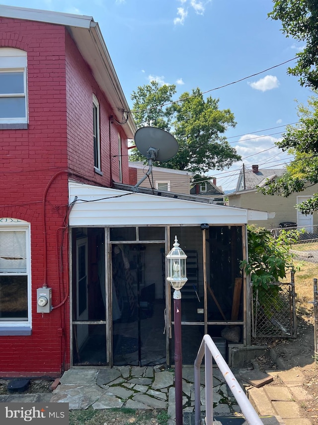 view of side of property with a sunroom