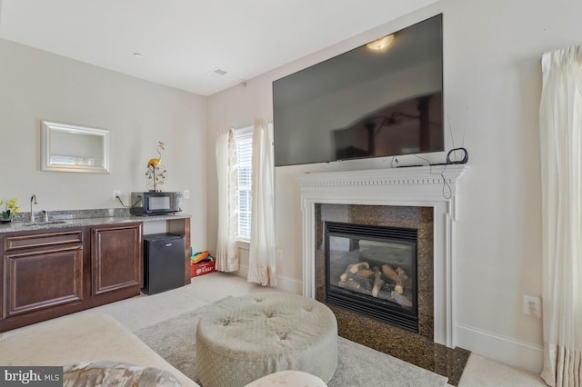 carpeted living room featuring sink